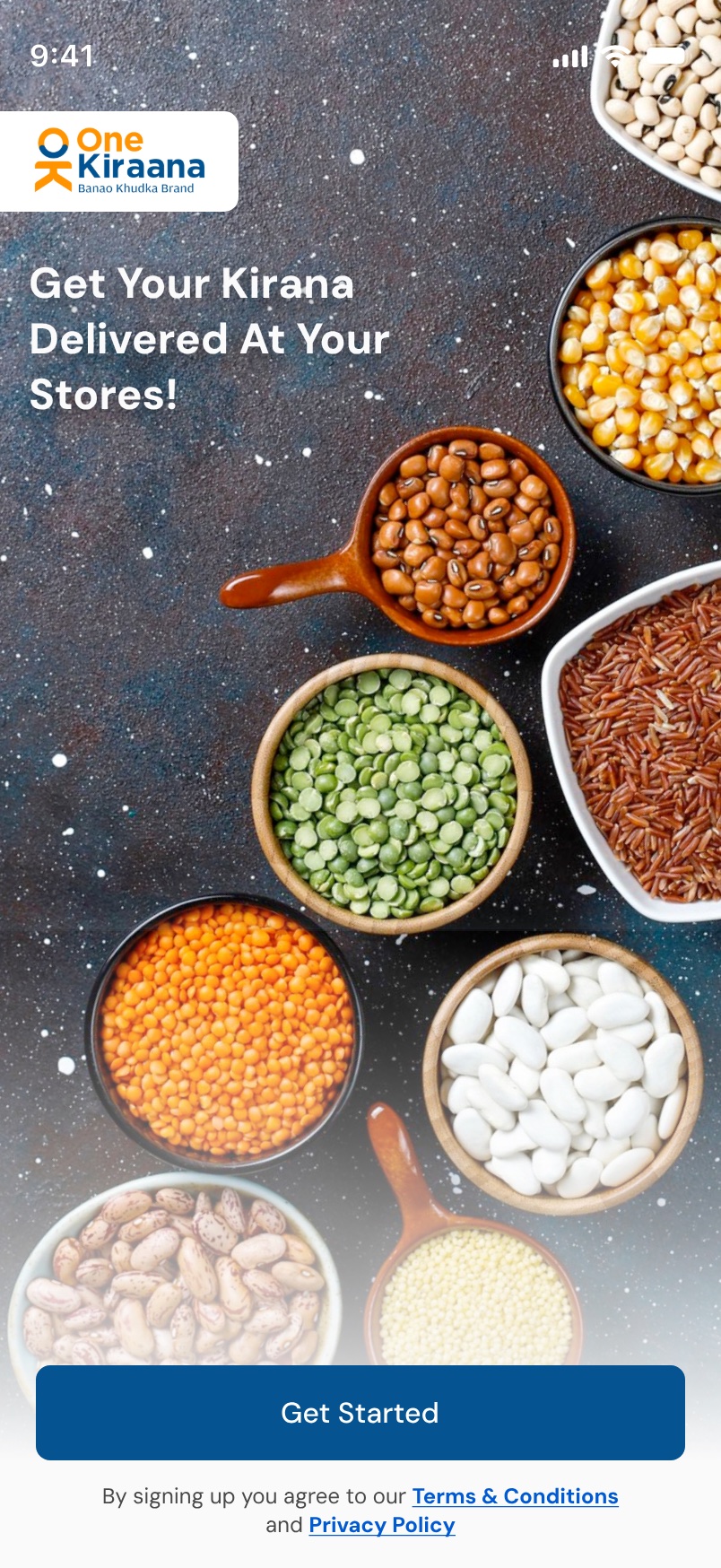 The opening screen: a full-bleed photograph of pulses and grains in bowls under the line Get Your Kirana Delivered At Your Stores, with the One Kiraana mark and a Get Started button.